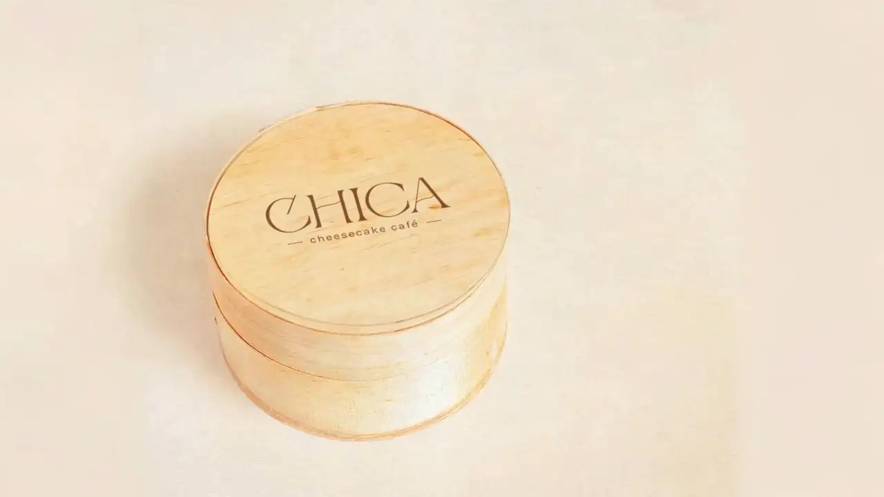 La caja de madera de CHICA, cerrada, con el logo grabado en la tapa